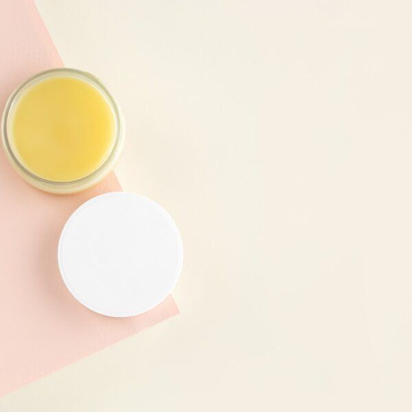 An open jar with Lanolin, a grease from sheep wool. Acts as a skin ointment, water-proofing wax